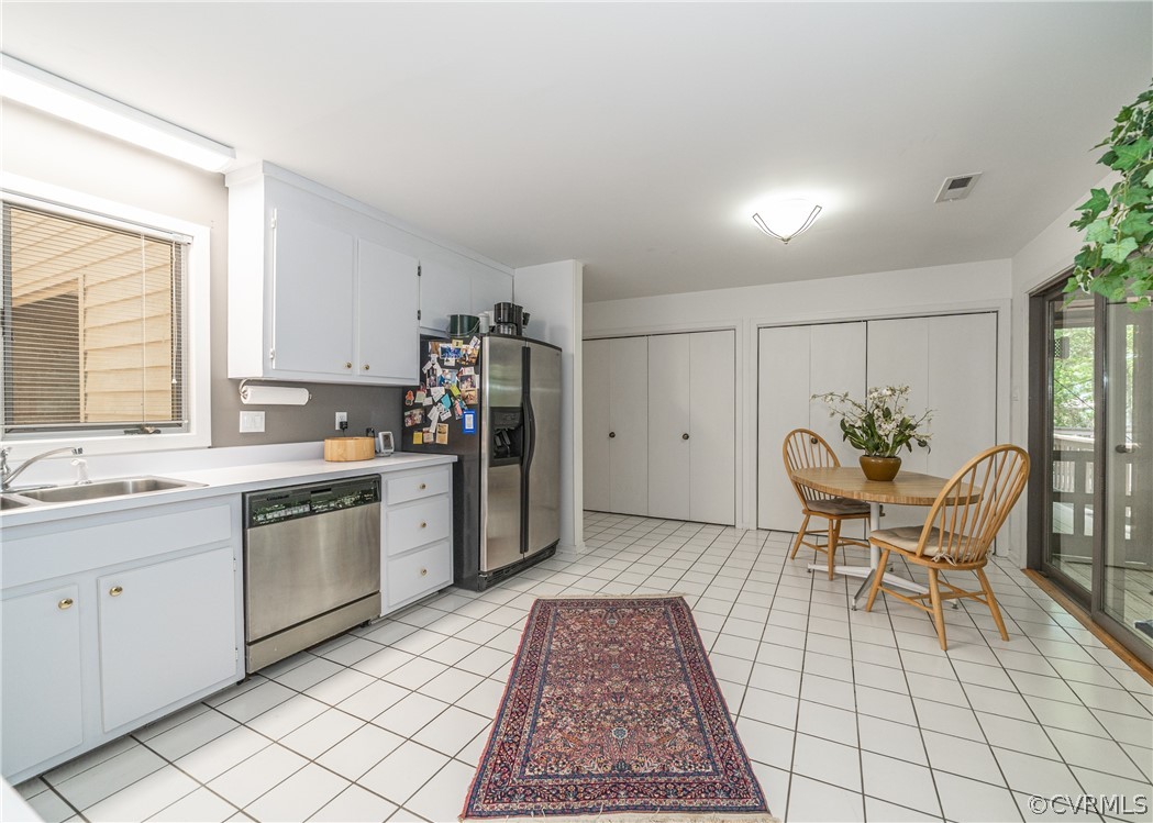3708 Commodore Point Circle Midlothian, VA 23112 - Photo 36 of 46 a kitchen with stainless steel appliances granite countertop a stove a sink a dining table and chair