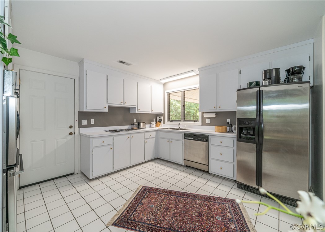 3708 Commodore Point Circle Midlothian, VA 23112 - Photo 37 of 46 a kitchen with a refrigerator sink and cabinets