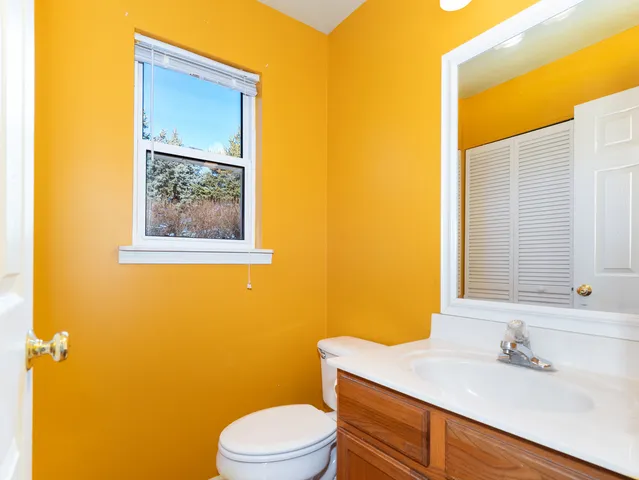 a bathroom with a sink mirror and toilet