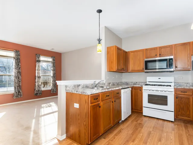 a kitchen with stainless steel appliances granite countertop a stove and a sink