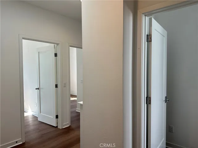 a view of a hallway with wooden floor