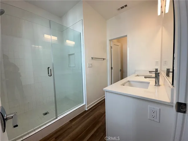 a bathroom with a sink a mirror and shower