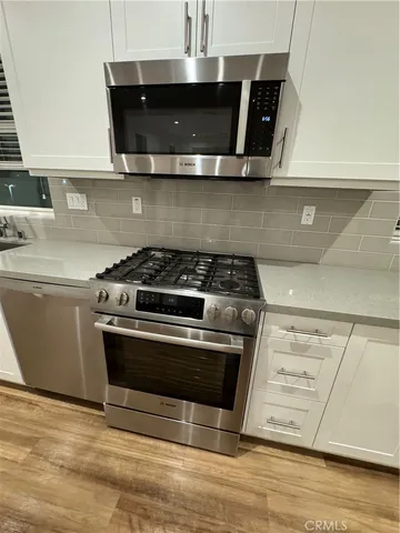 a stove top oven sitting inside of a kitchen