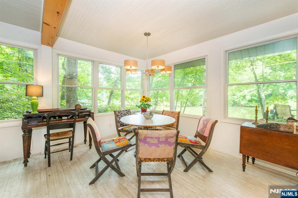 37 N Road Bloomingdale, NJ 07420 - Photo 14 of 18 a dining room with furniture a chandelier and wooden floor