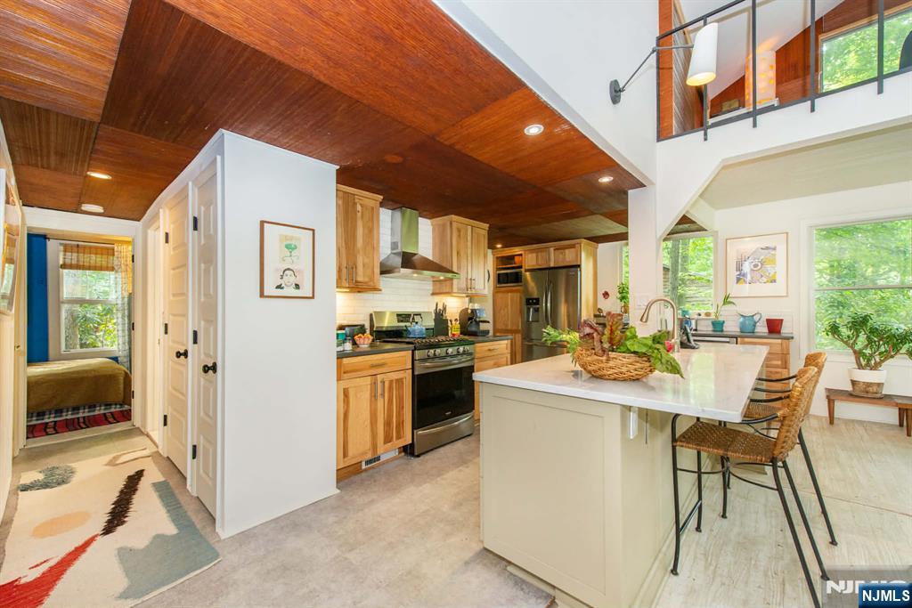37 N Road Bloomingdale, NJ 07420 - Photo 5 of 18 a living room with stainless steel appliances kitchen island granite countertop furniture and a kitchen view