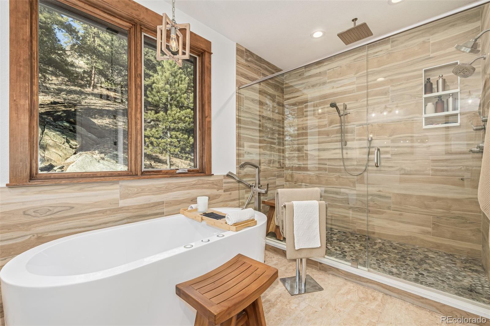 663 Brookside Drive Bailey, CO 80421 - Photo 17 of 47 a bath tub sitting next to a window
