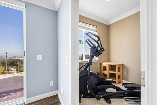 a bathroom with a granite countertop sink a toilet and a window