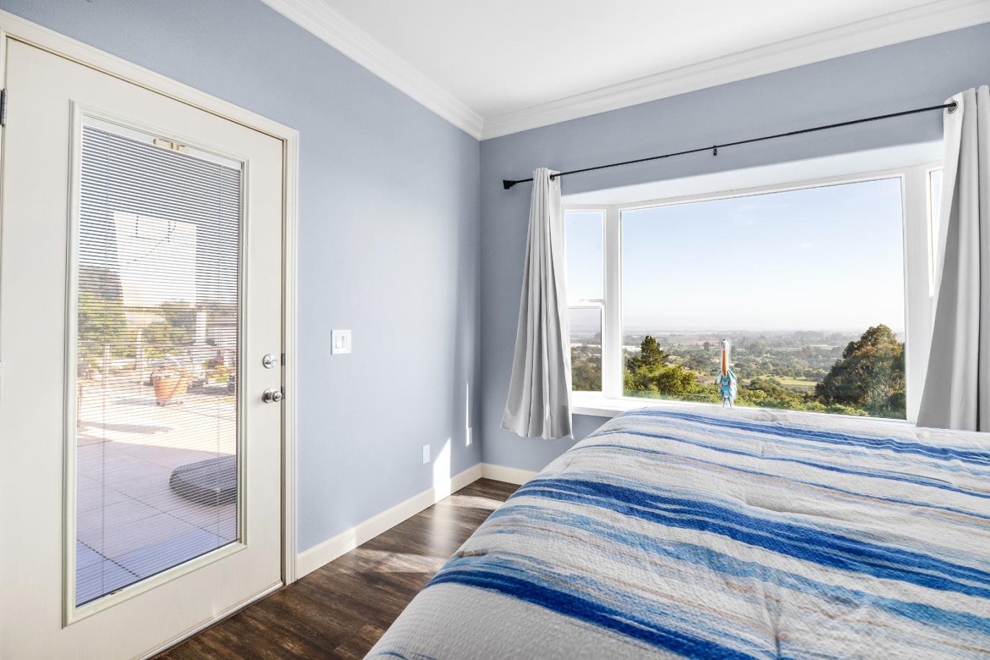 960 Smith Road Watsonville, CA 95076 - Photo 31 of 68 a bedroom with a bed and a large window with outer view