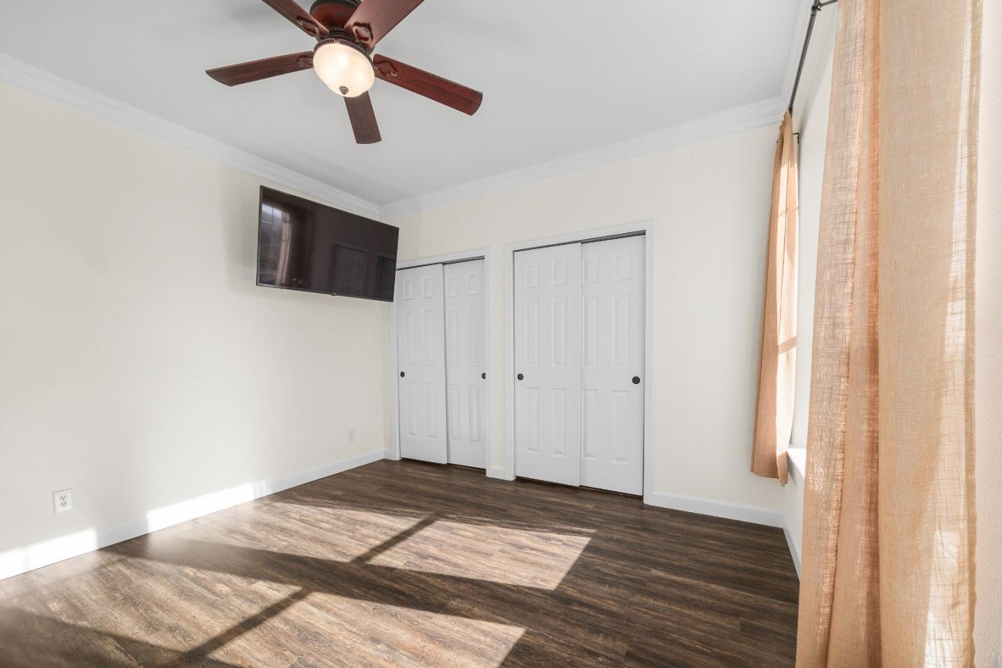 960 Smith Road Watsonville, CA 95076 - Photo 37 of 68 a view of a livingroom with wooden floor and a ceiling fan
