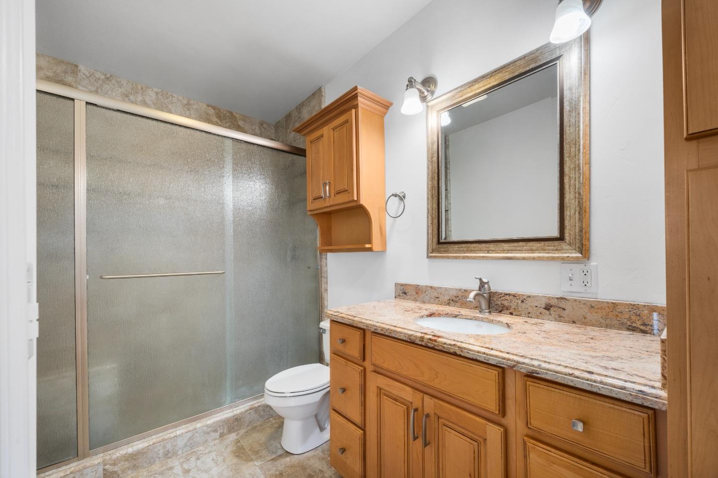 960 Smith Road Watsonville, CA 95076 - Photo 48 of 68 a bathroom with a granite countertop sink toilet and shower