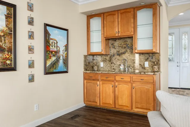 a bathroom with a granite countertop sink and a large mirror