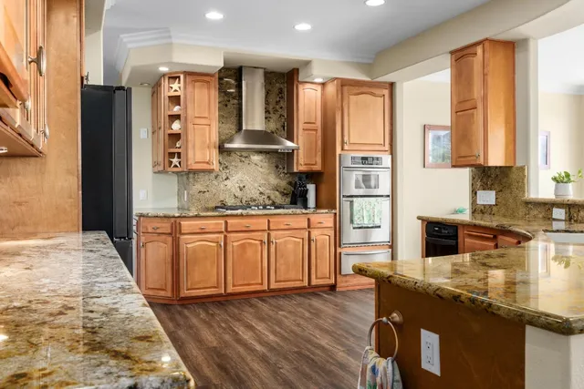 a kitchen with granite countertop a sink and a stove
