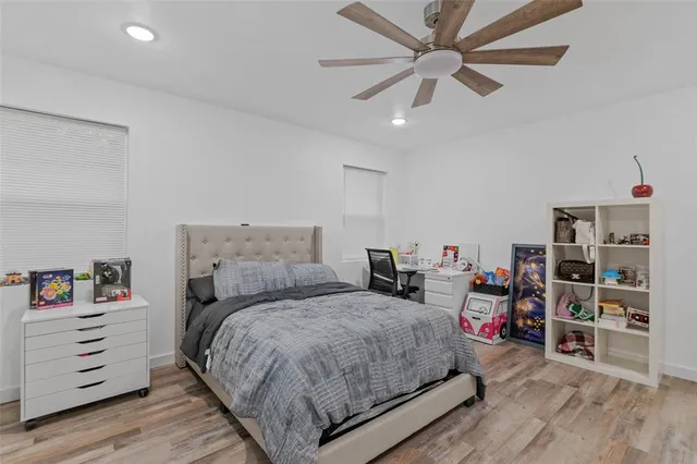a bedroom with a bed and a book shelf