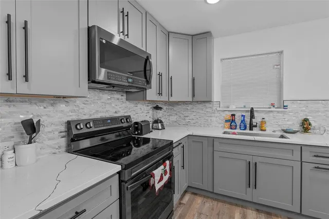 a kitchen with a sink and cabinets