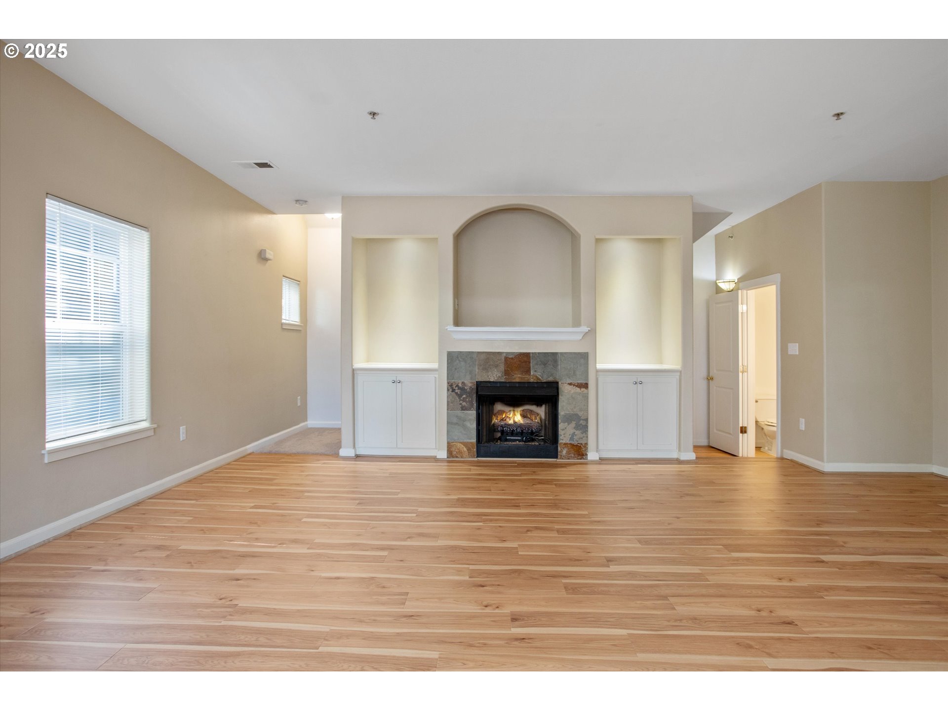 1000 Southwest 170th Avenue, Unit 201 Beaverton, OR 97003 - Photo 4 of 14 a view of empty room with wooden floor and fireplace