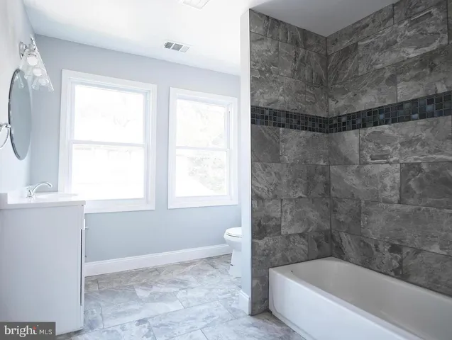 a bathroom with a bathtub and shower