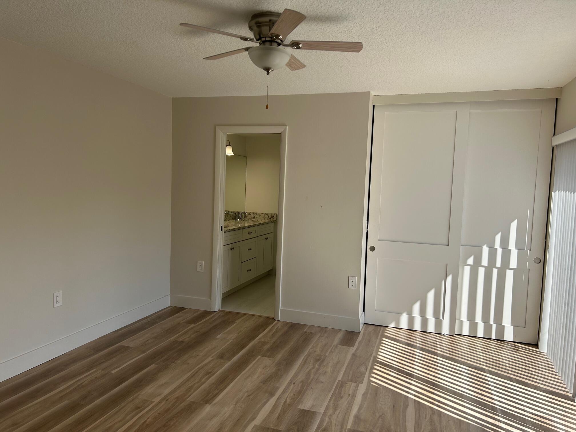 3105 31st Court, Unit 130D Jupiter, FL 33477 - Photo 13 of 24 a view of a hallway with a bedroom