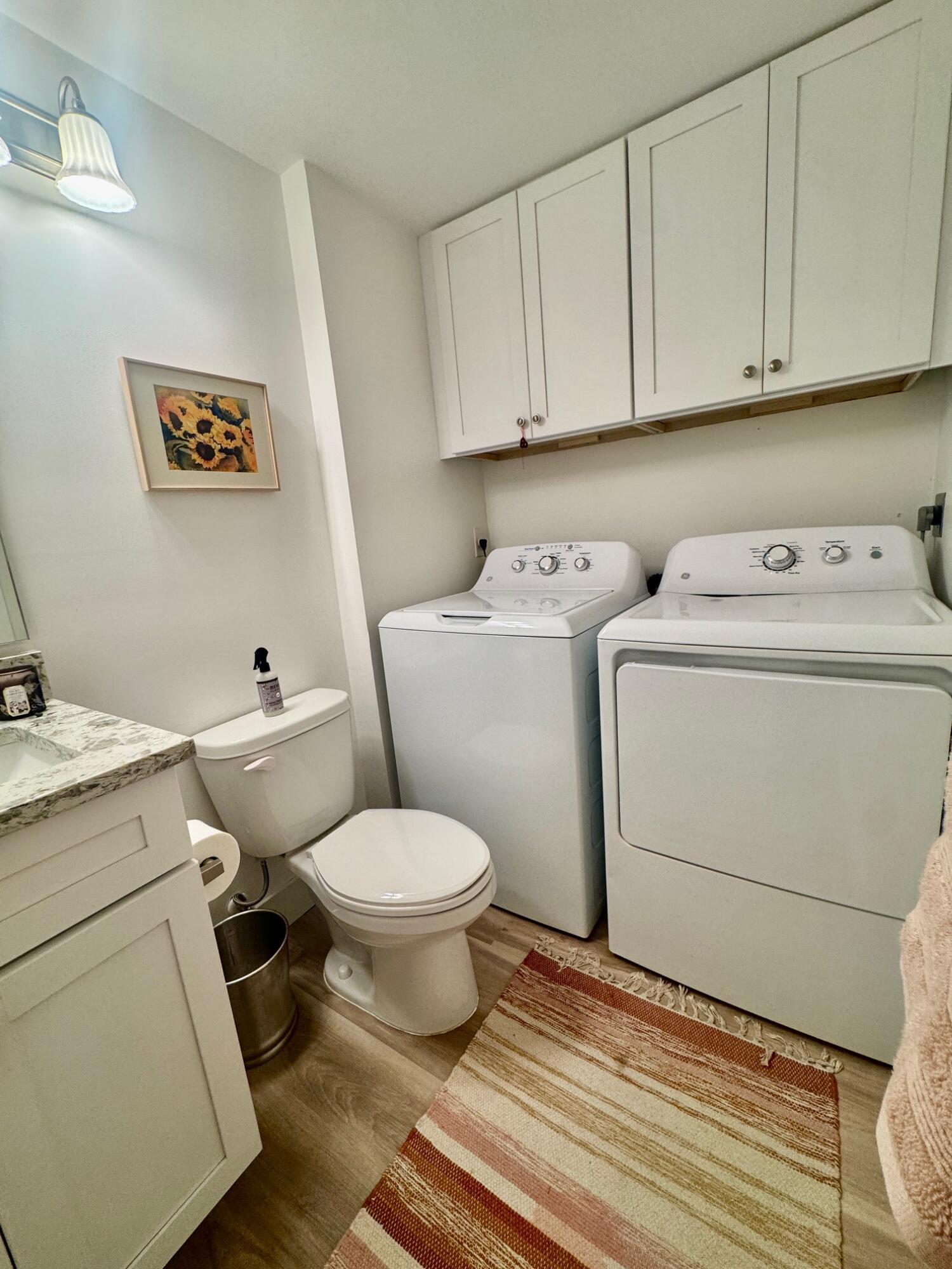 3105 31st Court, Unit 130D Jupiter, FL 33477 - Photo 16 of 24 a bathroom with a toilet and a washing machine