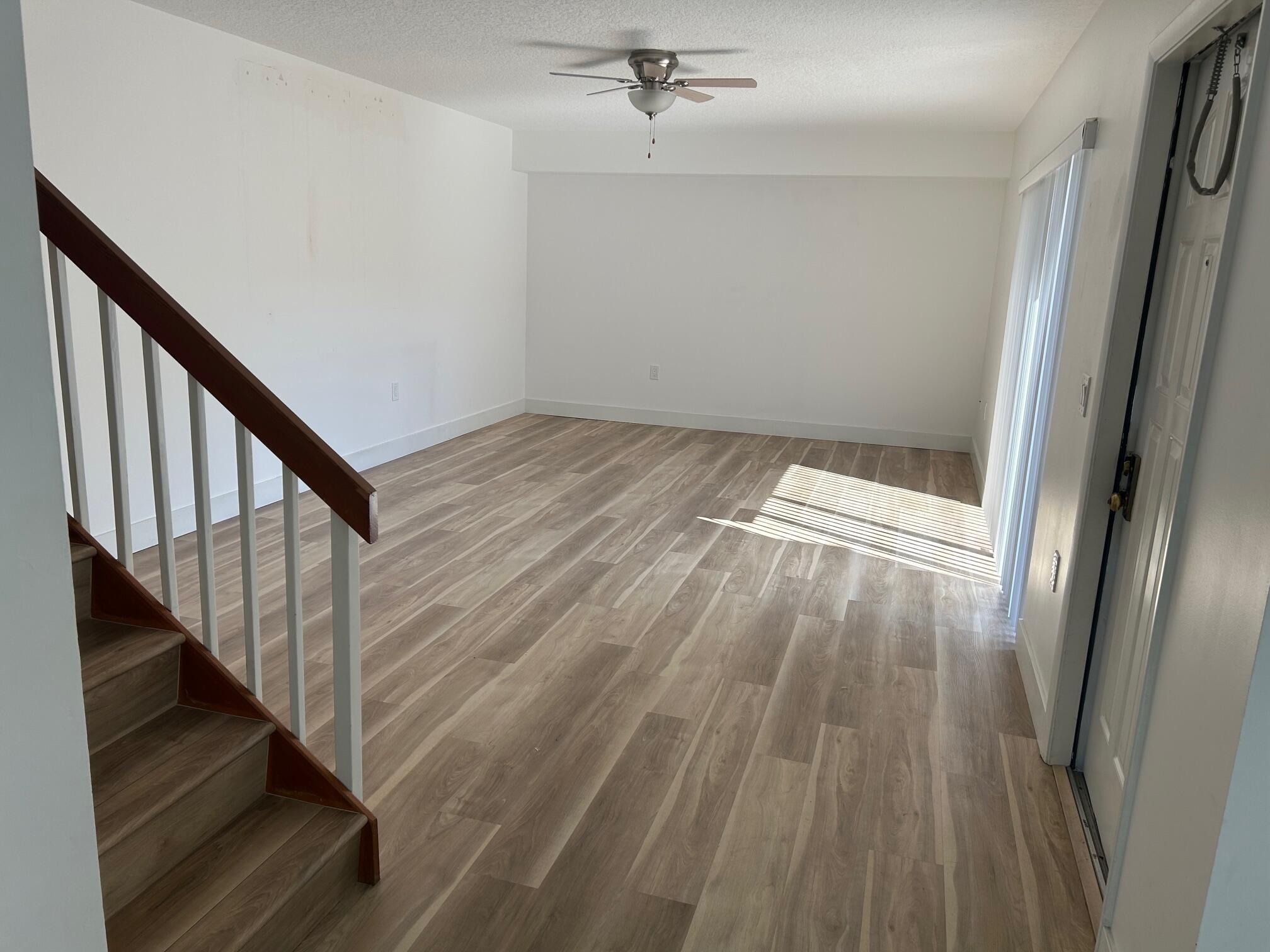 3105 31st Court, Unit 130D Jupiter, FL 33477 - Photo 8 of 24 a view of entryway with wooden floor
