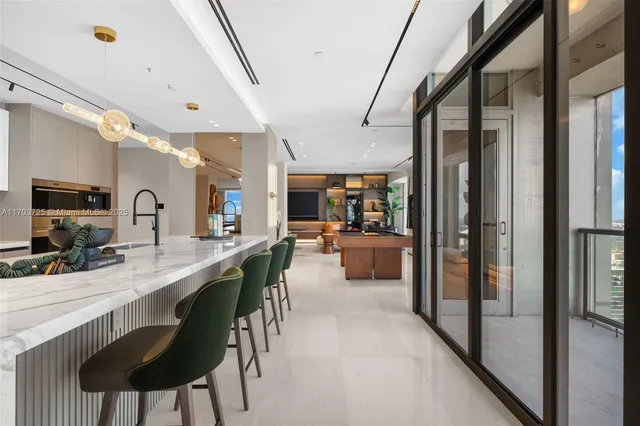 a living room with furniture large window and outdoor view