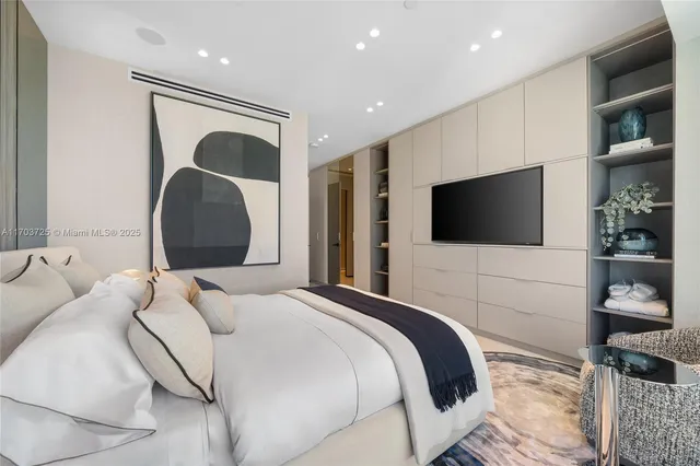 a bedroom with a bed and a large window