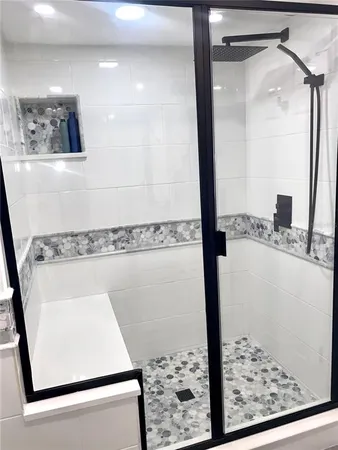 a bathroom with a shower and a mirror