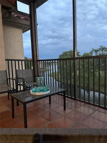a balcony with table and chairs