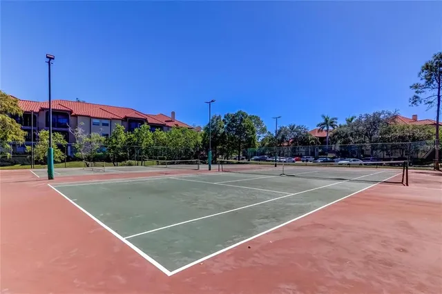 a view of kitchen with cabinets and window
