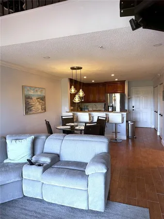 a living room with furniture and view of kitchen