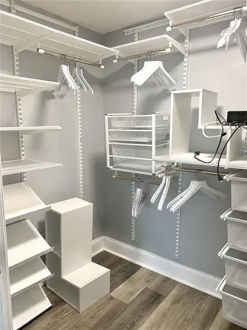 a view of entryway and hall with wooden floor