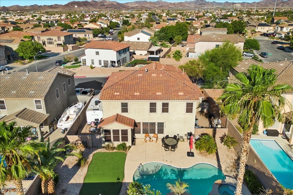249 Cinnamon Ridge Way Henderson, NV 89015 - Photo 64 of 76 Aerial perspective of suburban area with a mountainous background and a pool area