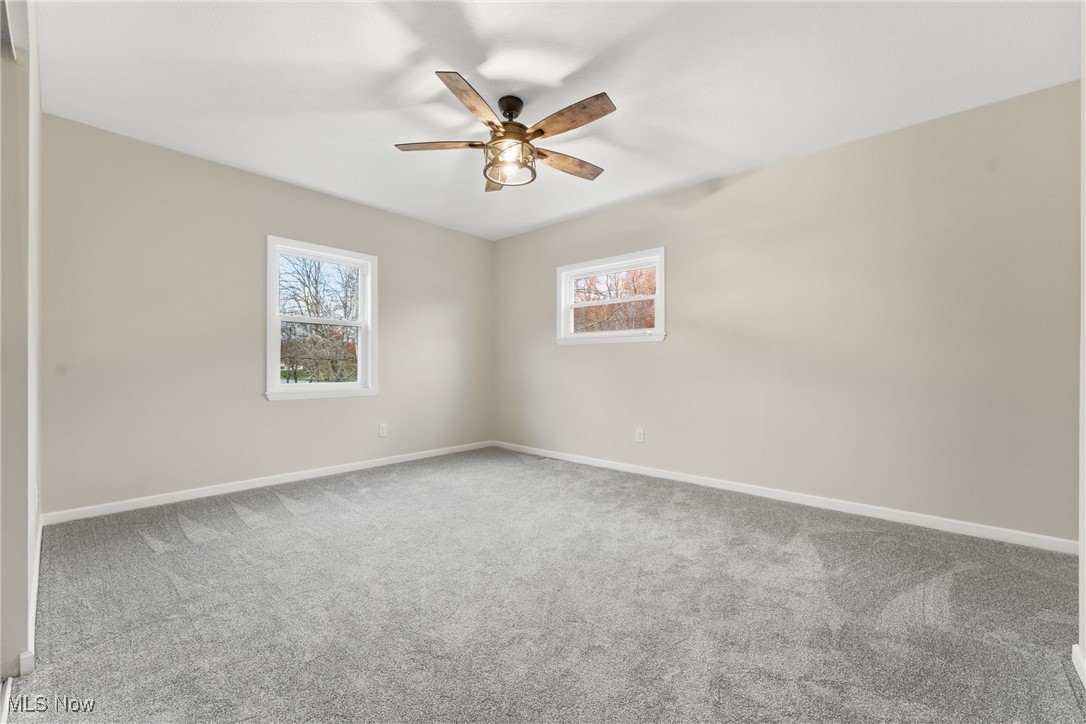 3793 Ranfield Road Kent, OH 44240 - Photo 27 of 40 Empty room featuring healthy amount of natural light, carpet, and ceiling fan