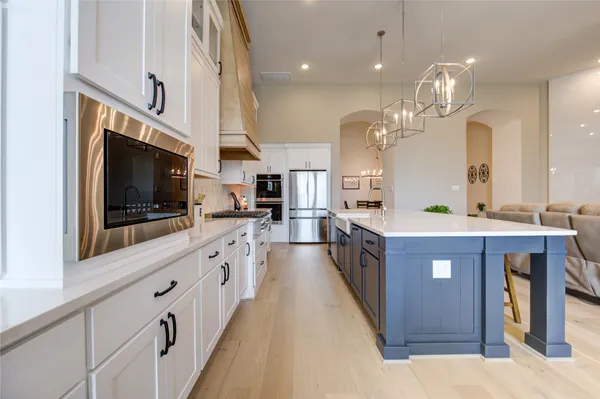 a large kitchen with stainless steel appliances kitchen island granite countertop a large counter top and stainless steel appliances