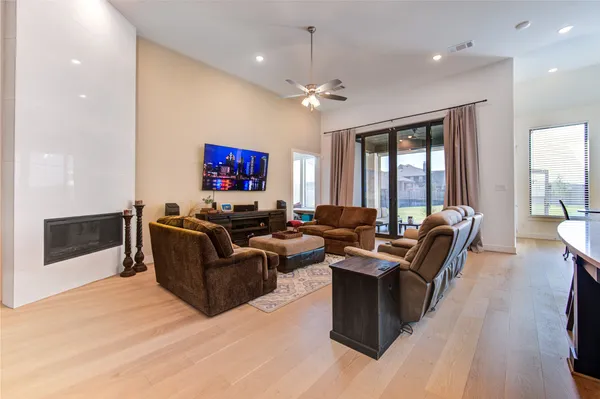 a living room with furniture a large window and a flat screen tv