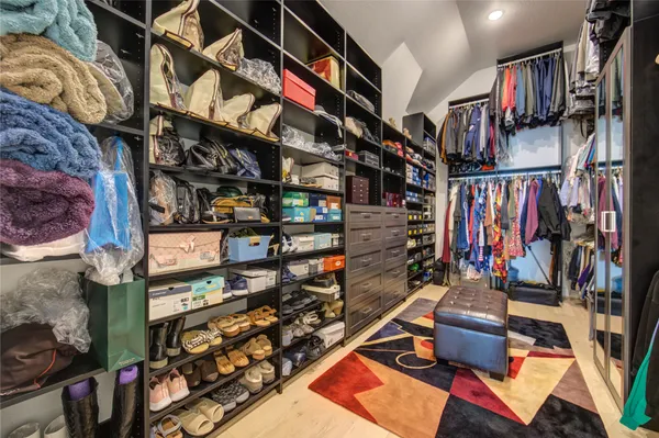 a view of walk in closet with clothes