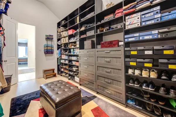 a room with a bed and a dresser