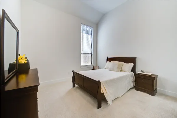 a bedroom with a bed and a fireplace