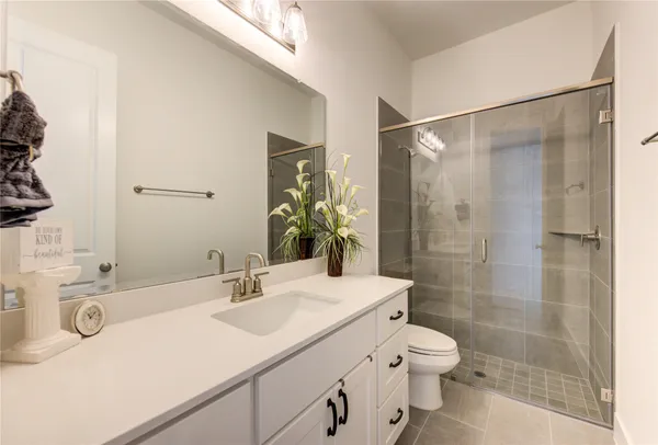 a bathroom with a sink a toilet and a shower curtain