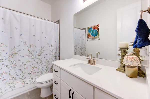 a kitchen with white cabinets a sink and dishwasher