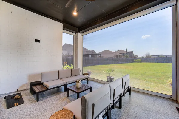 a living room with furniture and garden view
