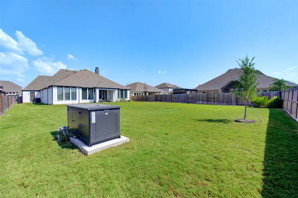 a swimming pool view with a seating space and a garden view