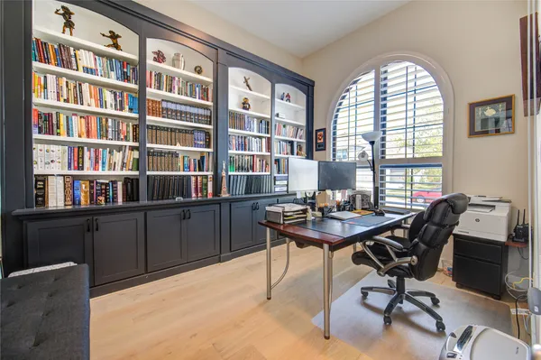 a workspace with furniture and a large window