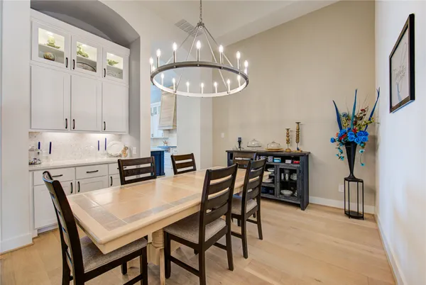 a view of a dining room with furniture and chandelier