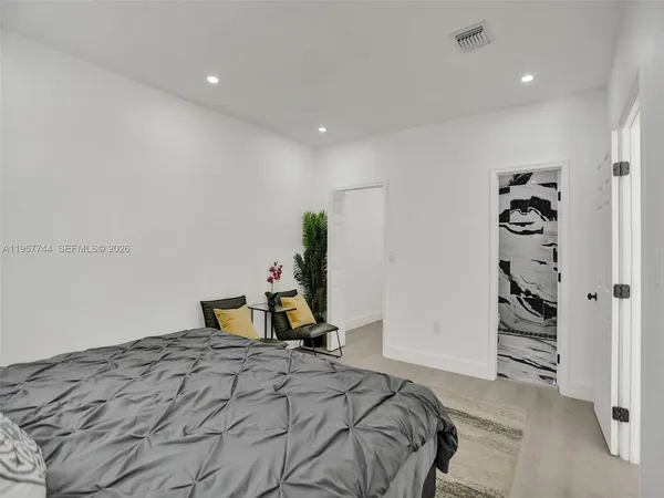 a bedroom with a bed and a walk in closet