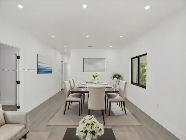 a dining room with furniture and window