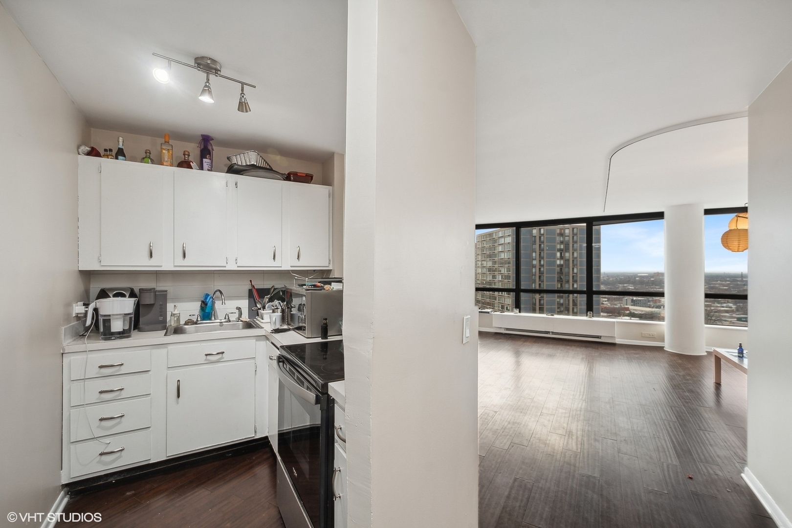 5415 North Sheridan Road, Unit 2103 Chicago, IL 60640 - Photo 2 of 12 a kitchen with a white cabinets and wooden floor
