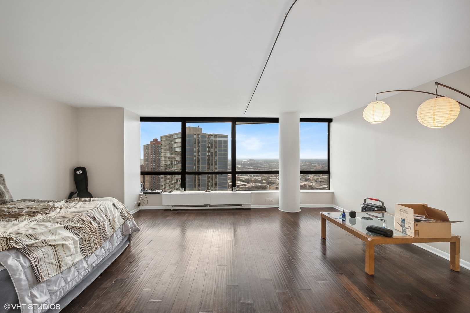 5415 North Sheridan Road, Unit 2103 Chicago, IL 60640 - Photo 4 of 12 a large bedroom with a bed and wooden floor