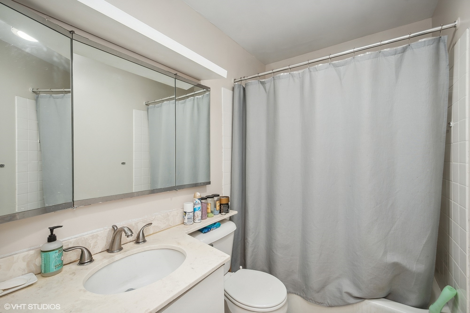 5415 North Sheridan Road, Unit 2103 Chicago, IL 60640 - Photo 8 of 12 a bathroom with a sink a toilet and shower curtain
