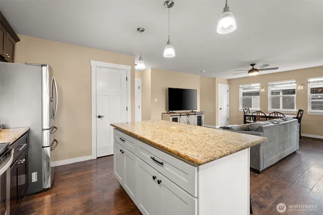a kitchen with a stove and a refrigerator
