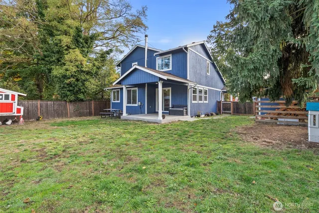 a backyard of a house with table and chairs